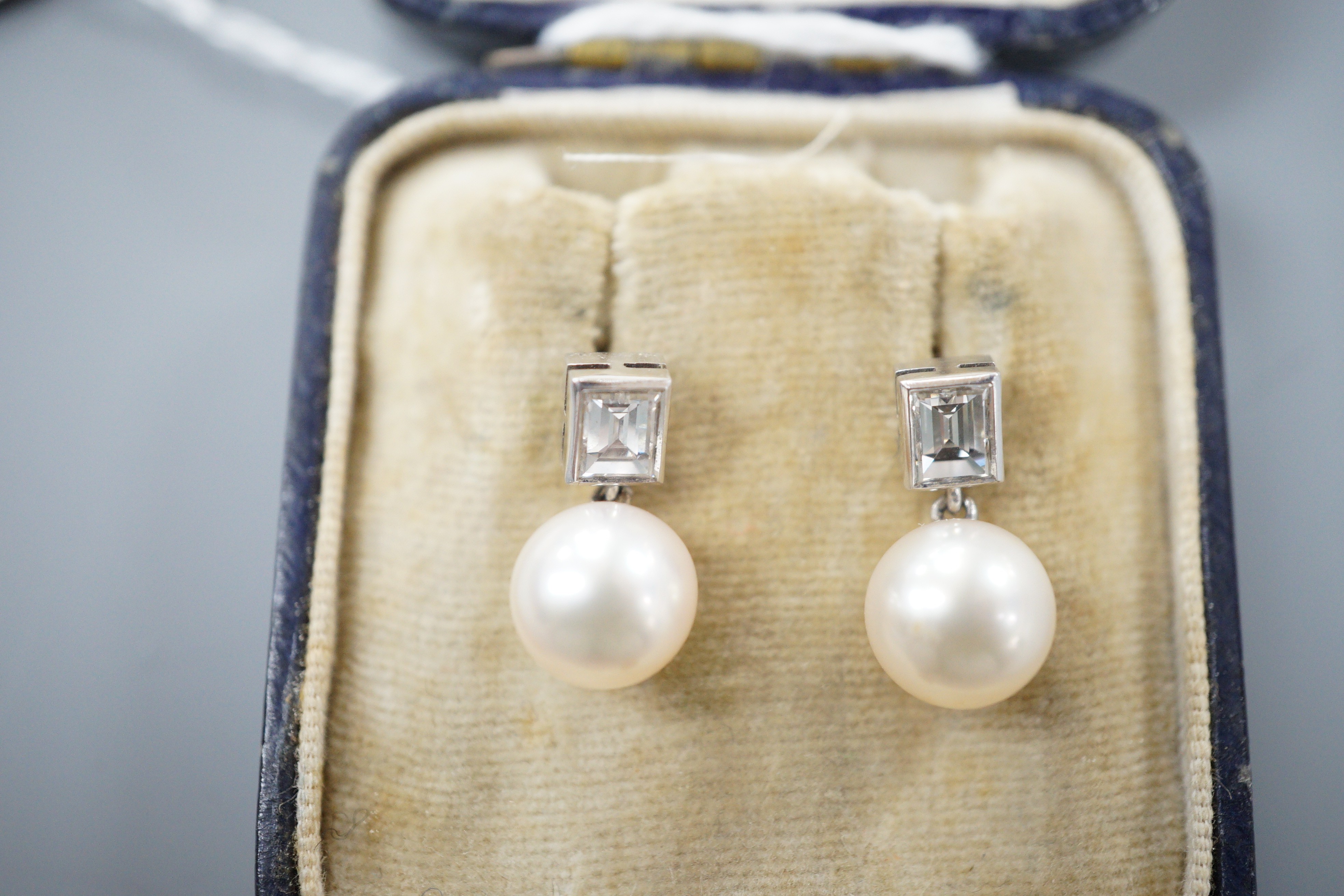 A pair of 18ct white metal, cultured pearl and diamond set drop earrings, 17mm, gross weight 4.3 grams.